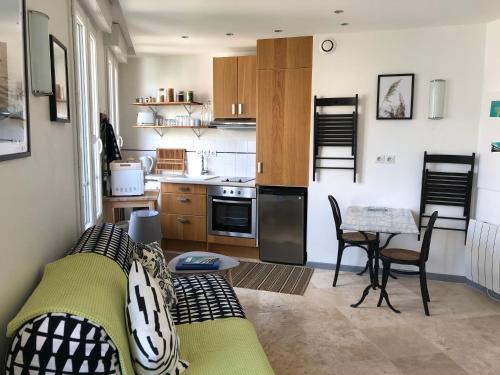 un petit salon avec un canapé et une table dans l'établissement 2 pièces- rue piétonne Trouville -Le petit juliana, à Trouville-sur-Mer