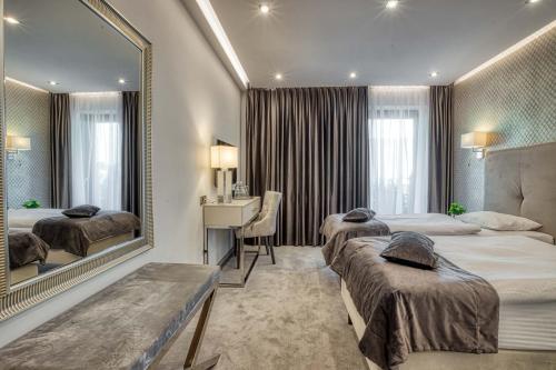 Postel nebo postele na pokoji v ubytování Hotel Biały Dom