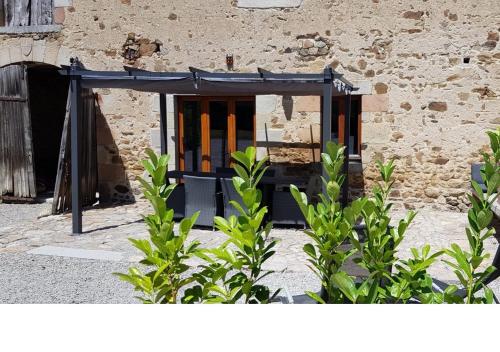 an open door of a building with green plants at Gites Le Grand Tornage in Évaux-les-Bains
