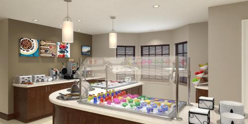 a kitchen with a display case filled with soda bottles at Staybridge Suites Waco South - Woodway by IHG in Woodway