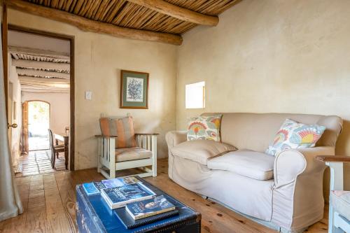 a living room with a couch and a table at Natte Valleij in Klapmuts