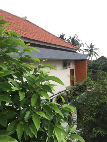 a house with a fence in front of it at Cahaya Guest House in Ubud