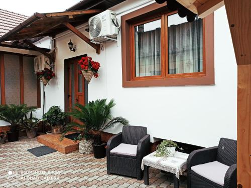 een patio met stoelen en een tv aan de zijkant van een huis bij Casa Elena in Sibiu