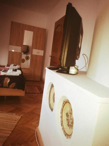 a tv sitting on top of a white stand in a room at Pensiunea Costesti in Costeşti