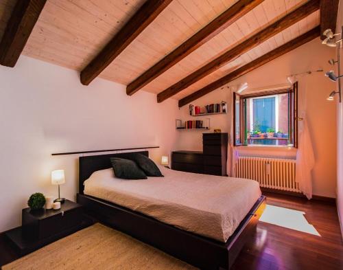 - une chambre avec un grand lit et une fenêtre dans l'établissement Ca’ Orti, à Venise
