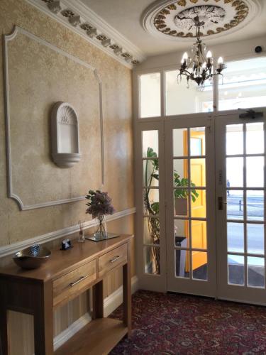 a bathroom with a sink and a mirror on the wall at Helmsman Guesthouse in Aberystwyth