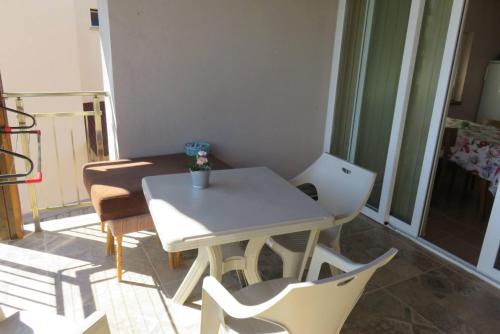 a small room with a table and chairs on a balcony at Guest House 51 in Kranevo