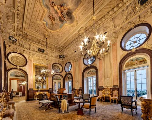 an ornate room with a chandelier and a living room at Pousada Palacio de Estoi – Small Luxury Hotels of the World in Estói