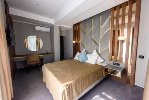 Un pat sau paturi într-o cameră la Vila Time Olimp