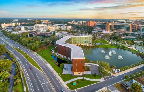 an aerial view of a city with a building and a river at Hotel Eleo at the University of Florida in Gainesville