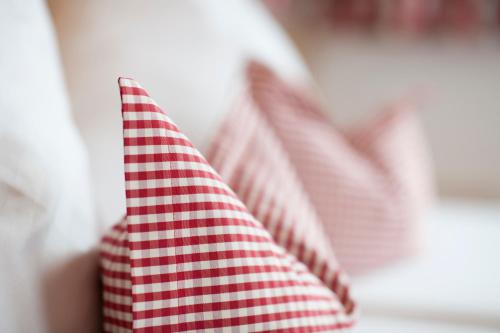 a red and white flag in front of a window at Hotel Angelika in Neustift im Stubaital