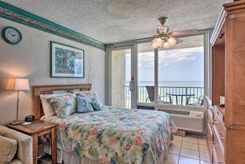 a bedroom with a bed with a view of the ocean at Oceanfront Daytona Beach Studio with Balcony in Daytona Beach Shores
