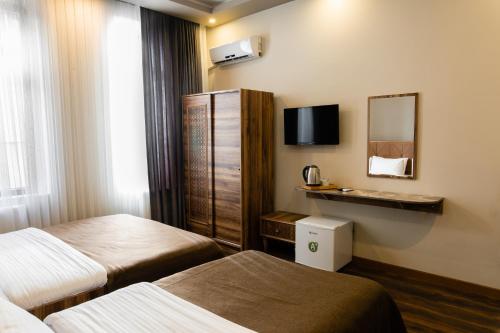 a hotel room with two beds and a mirror at Taksim Mood in Istanbul