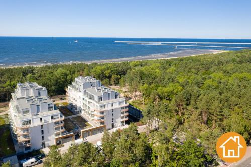 an aerial view of two white buildings next to a beach at Apartamenty ApartPark - visitopl in Świnoujście