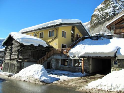 a house with snow on the side of it at Miramonti in Valtournenche