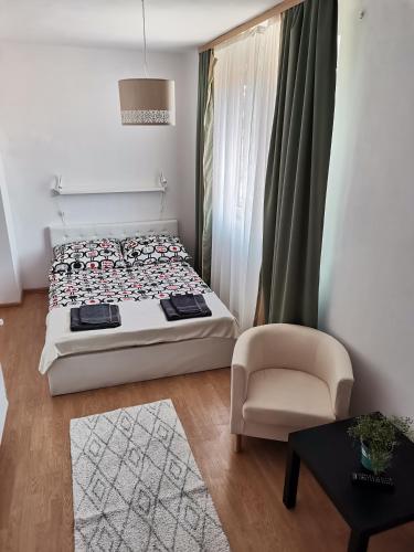 a small bedroom with a bed and a chair at Oliwier in Rewal