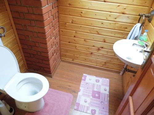 a bathroom with a toilet and a sink at Béke Vendégház in Szada