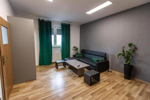a living room with a couch and a table at Nepomucen in Gołąb