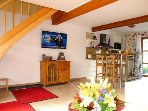 a kitchen and living room with a tv on the wall at Holiday Home Tribbevitz by Interhome in Tribbevitz