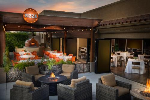 a patio with chairs and tables and a restaurant at The Scottsdale Plaza Resort & Villas in Scottsdale