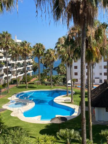 a view of the pool from the balcony of a resort at Mi Capricho Apartment with Sea Views and Gardens in La Cala de Mijas