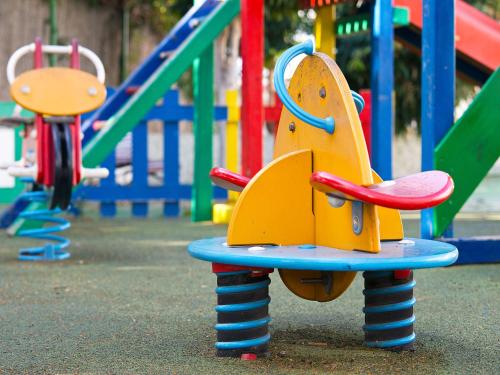 a playground with colorful play equipment in a park at Bungalows Vistaflor in Maspalomas