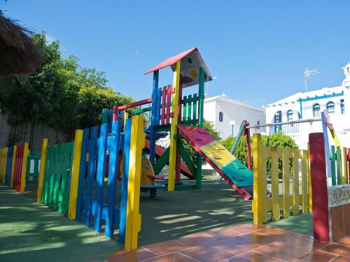 a playground with colorful play equipment in a park at Bungalows Vistaflor in Maspalomas