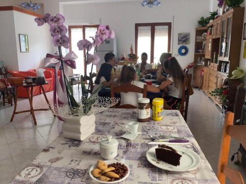 a group of people sitting at a table with cake at L'Oasi in Auletta