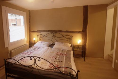 a bedroom with a bed with a wrought iron headboard at Historisch übernachten Brinkerplatz 3 in Essen