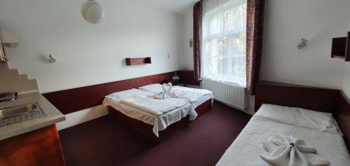 a hospital room with two beds and a sink at Hotel Jerabek in Prague