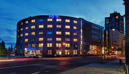 a large building with a clock on the side of it at Hotel am Borsigturm in Berlin