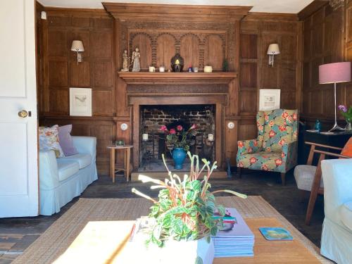 a living room filled with furniture and a fire place at Baye House in Colchester