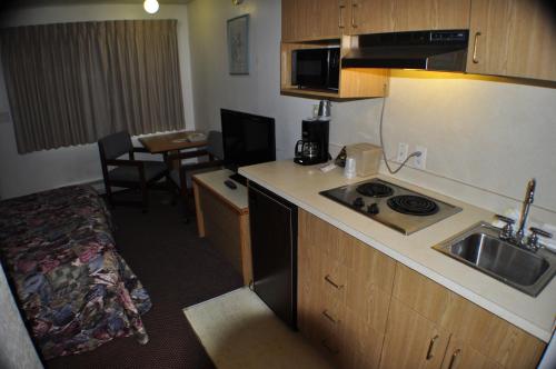 a small kitchen with a sink and a stove in a room at Uptown Inn in Port Angeles