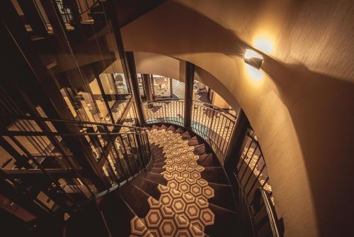 an overhead view of a spiral staircase in a building at Hotel Bernina Geneva in Geneva