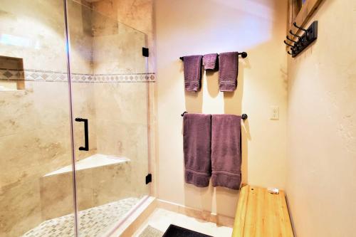 a bathroom with a glass shower and purple towels at Hot Tub and Lake Tahoe Views Kings Beach Lodge in Kings Beach