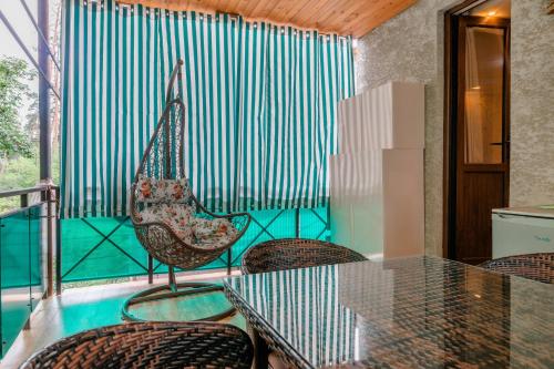a balcony with a table and chairs and a pool at Borjomi Villa Roma in Borjomi