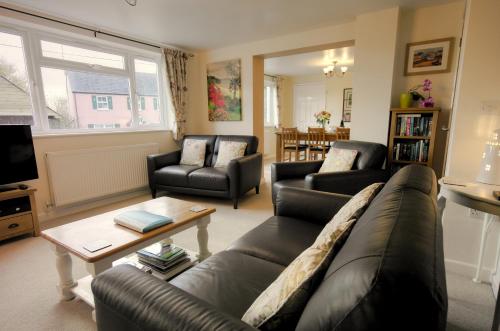 a living room with couches and a coffee table at The East Wing @ Lower Broom Farm in Kilgetty