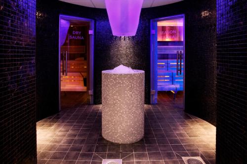 a stone trash can in a room with purple lights at Clarion Hotel Sense in Luleå