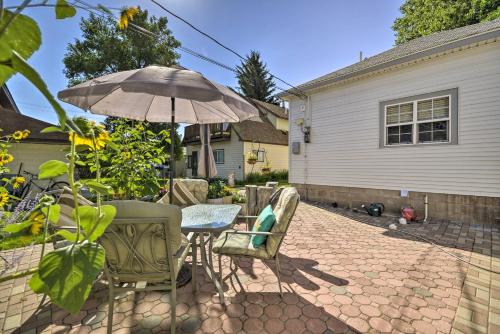 a patio with a table and chairs and an umbrella at Well-equipped Cody Cottage 2 Miles to Cody Rodeo! in Cody