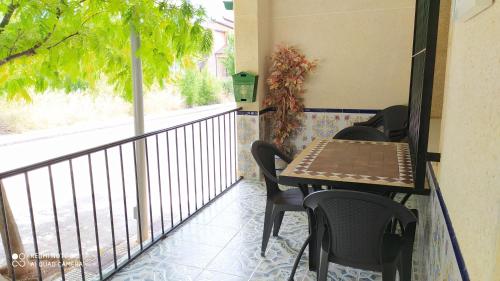 a balcony with a table and chairs and a window at Casa Rural El Cerrete 2 in Riópar