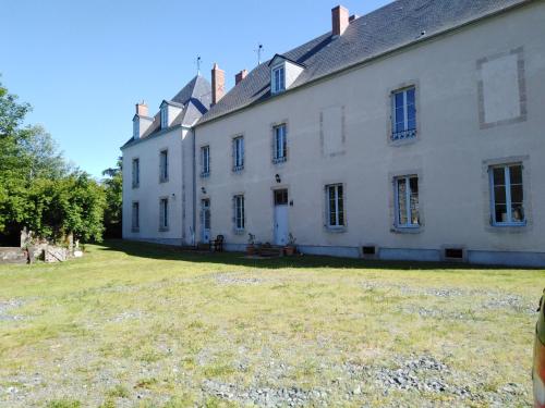 a large white house with a large yard at Chateau de Linard in Linard