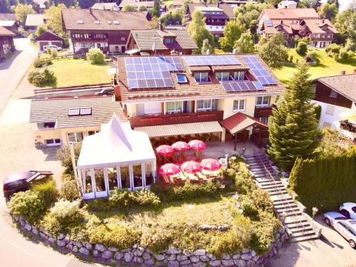 an aerial view of a house with a solar roof at Helgas Landhotel in Oberreute