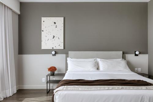 Кровать или кровати в номере Caesar Business Belo Horizonte Belvedere