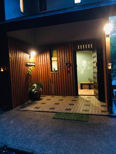 a front door of a building at night at 大人スイート 那須高原 結 cottage in Nasu