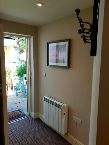 a room with a radiator and a picture on the wall at The Pelican Inn in Devizes