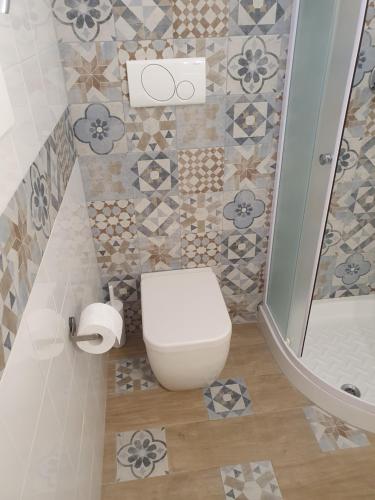 uma casa de banho com um WC e um chuveiro em Locazione turistica Le Vele em Pulsano