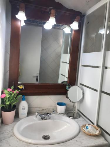 a bathroom with a sink and a mirror at Apartamento Rural situado en tercera planta sin ascensor in Navás