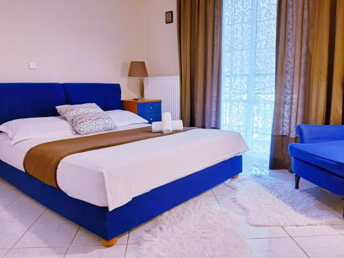 a bedroom with a blue bed and a blue chair at Kalliopi's apartment in Athens
