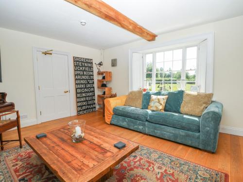 a living room with a couch and a table at Groomes Country House in Bordon