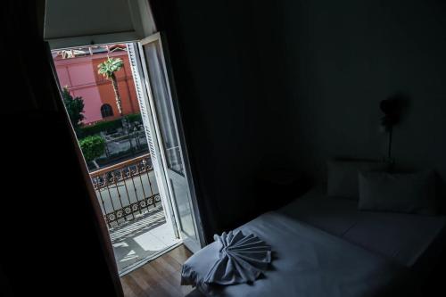 a room with a bed and a window with a umbrella at My Hotel in Cairo